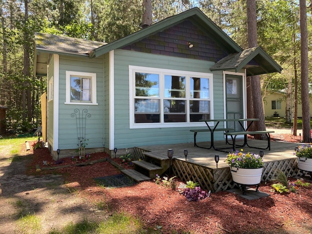 rear view of house with a wooden deck