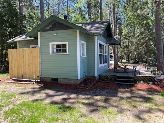 view of property exterior featuring a wooden deck