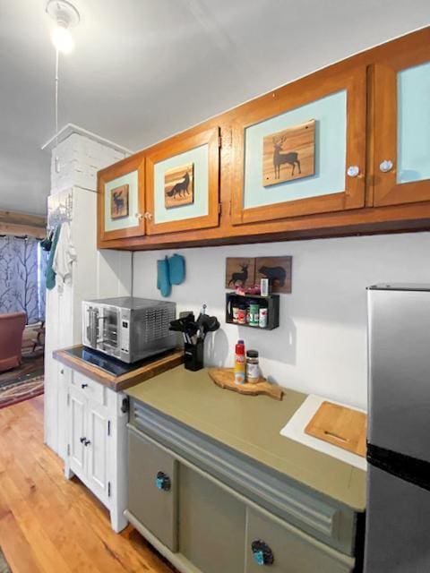 kitchen with appliances with stainless steel finishes and light wood-type flooring