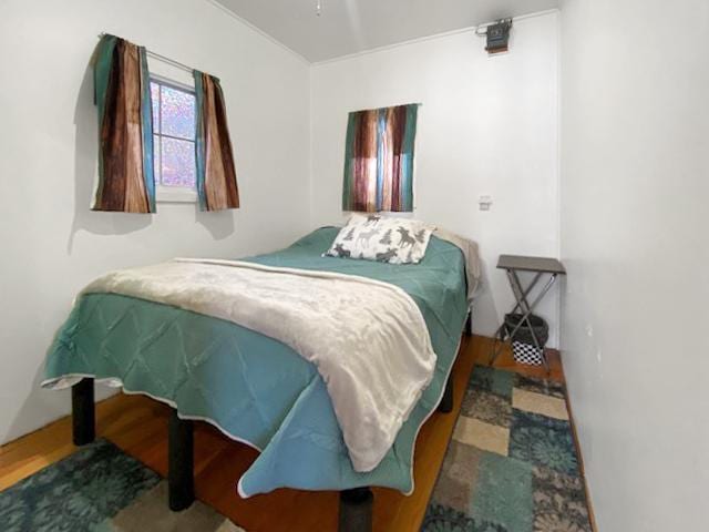 bedroom with wood-type flooring