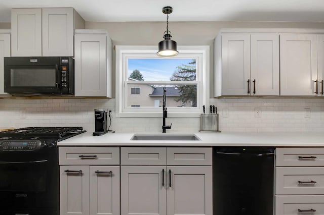 kitchen with backsplash, white cabinetry, sink, and black appliances