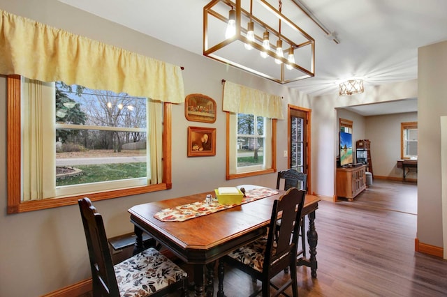 dining room featuring hardwood / wood-style floors and a chandelier