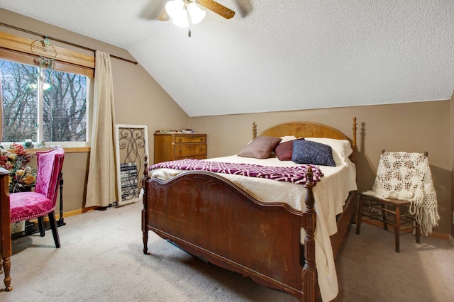 bedroom featuring a textured ceiling, ceiling fan, light colored carpet, and lofted ceiling