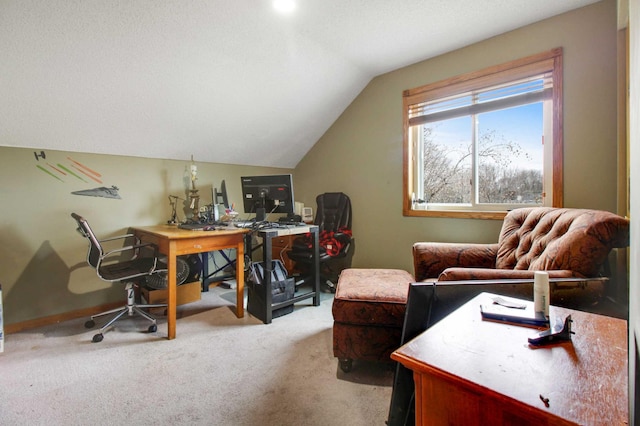 carpeted home office with lofted ceiling