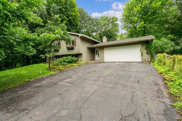 tri-level home with a front yard and a garage