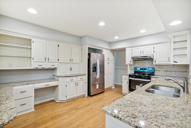 kitchen with light stone counters, sink, white cabinets, and stainless steel appliances