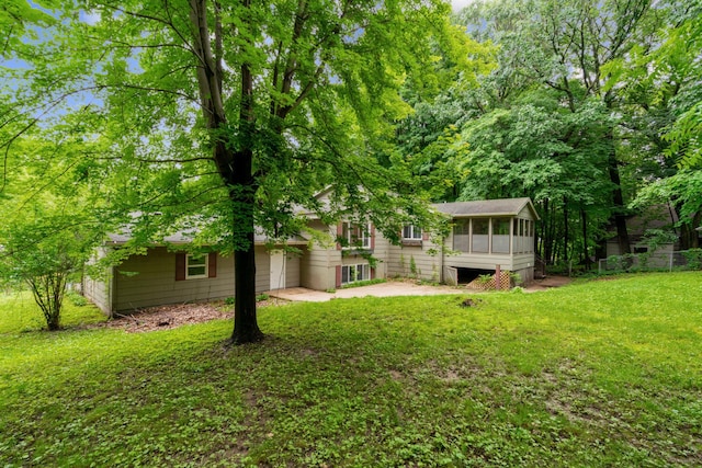 view of yard with a patio area and a sunroom