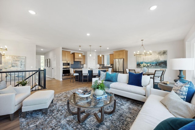 living room with dark hardwood / wood-style flooring and an inviting chandelier