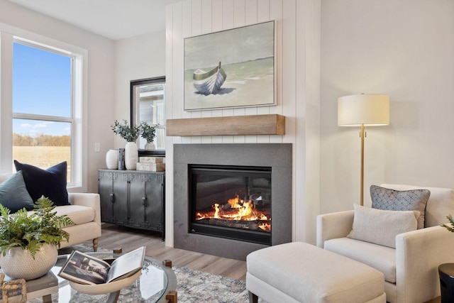 living area with light wood-type flooring and a fireplace