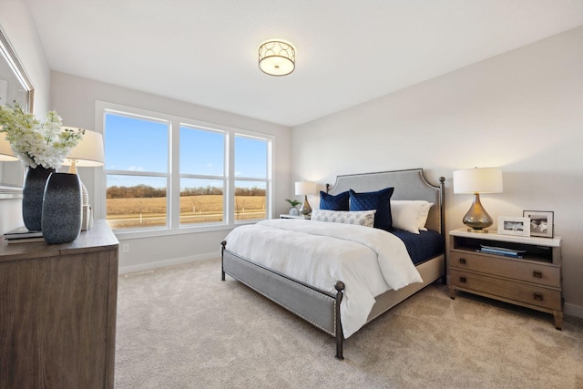 bedroom featuring light colored carpet