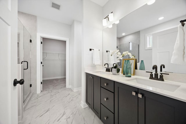 bathroom featuring walk in shower and vanity