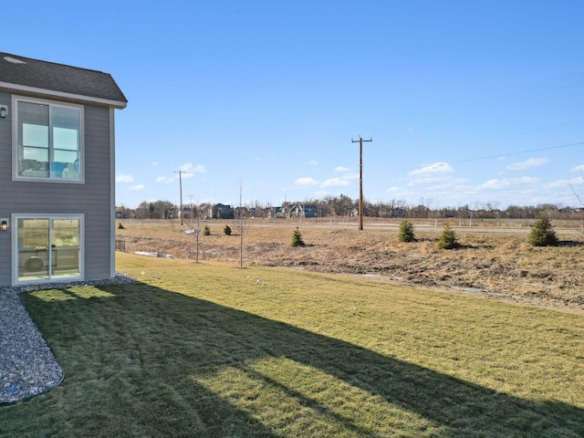 view of yard with a rural view