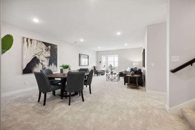 dining area featuring light colored carpet