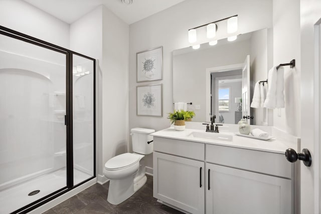 bathroom featuring walk in shower, vanity, and toilet