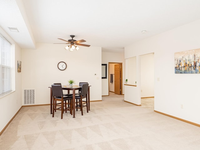 carpeted dining space featuring ceiling fan