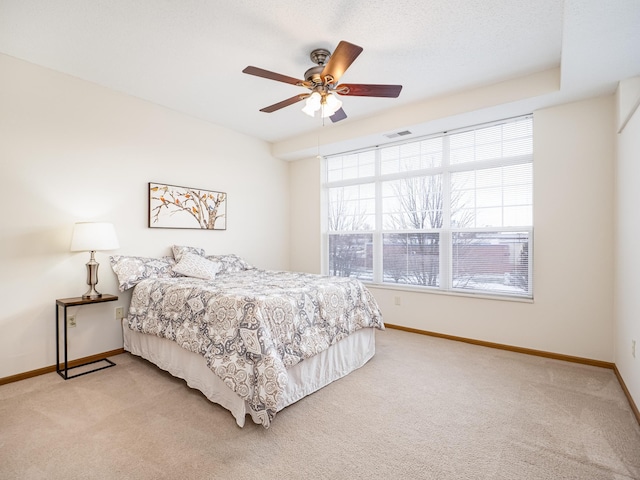 bedroom featuring ceiling fan and light colored carpet