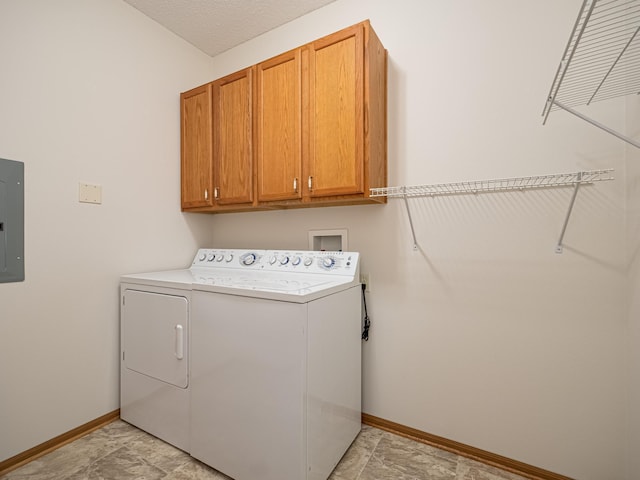 laundry area with cabinets, a textured ceiling, electric panel, and washer and dryer