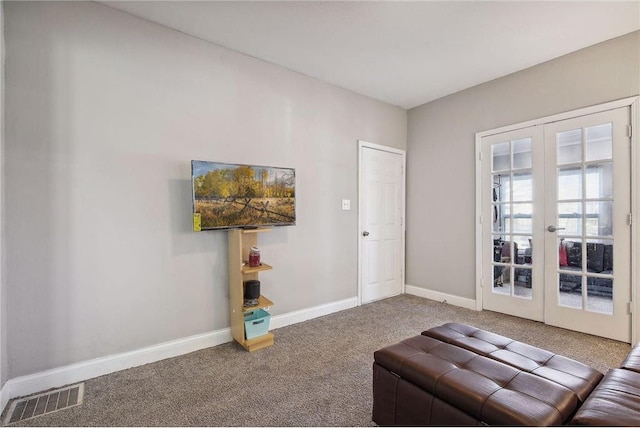 unfurnished room featuring french doors and carpet