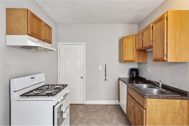 kitchen featuring white appliances, sink, and carpet floors