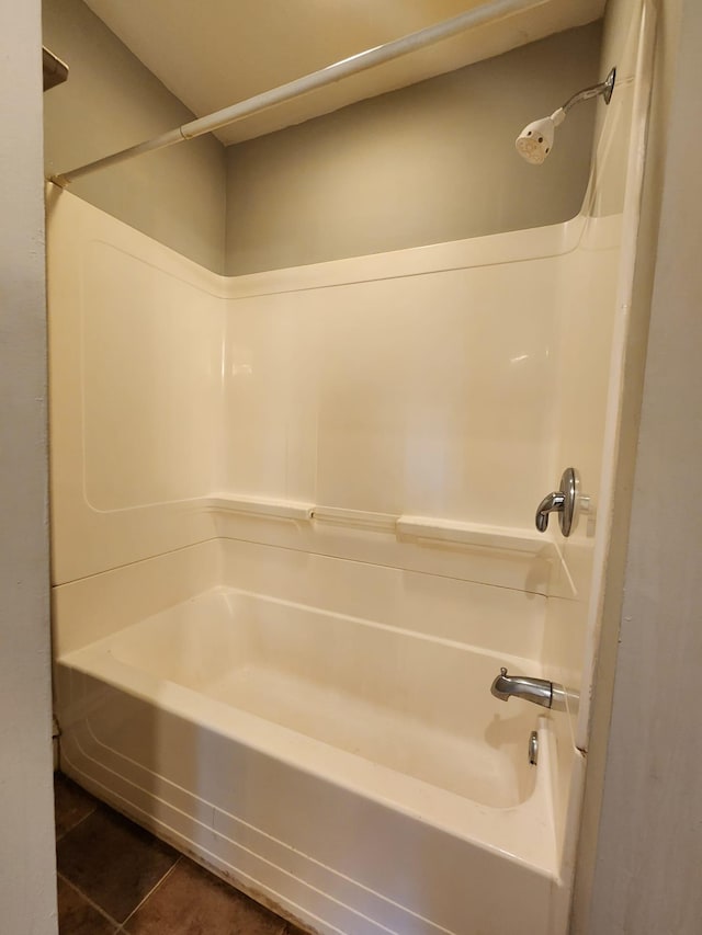 bathroom featuring tile patterned floors and  shower combination