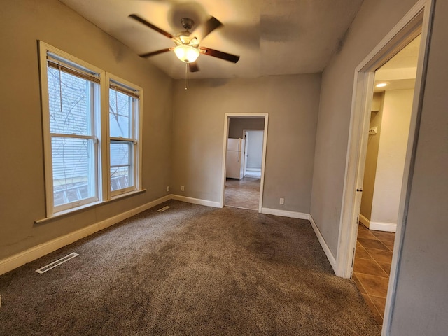 carpeted empty room with ceiling fan