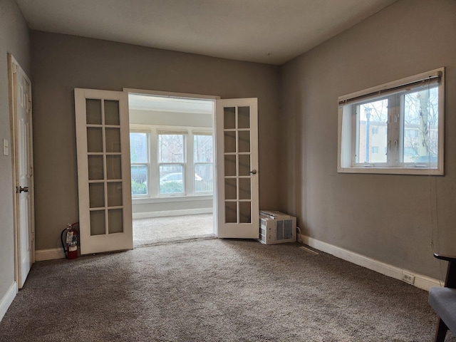 carpeted spare room with french doors