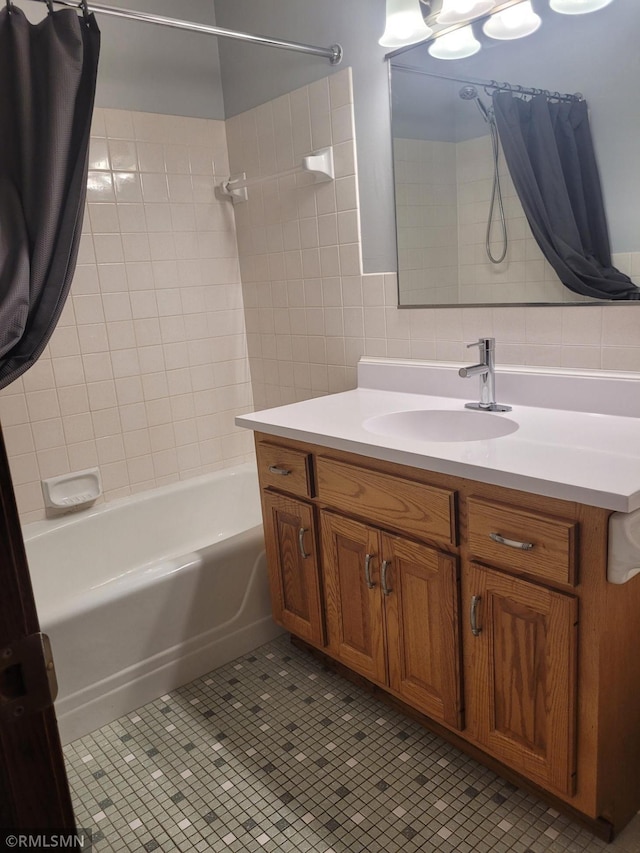 bathroom with decorative backsplash, vanity, shower / bath combo with shower curtain, tile walls, and tile patterned flooring