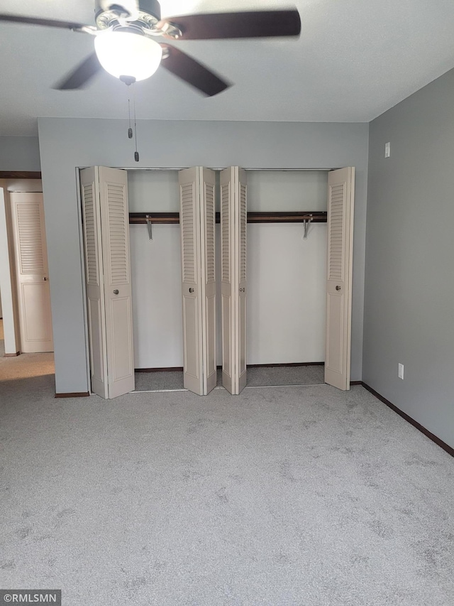 unfurnished bedroom featuring light carpet, two closets, and ceiling fan