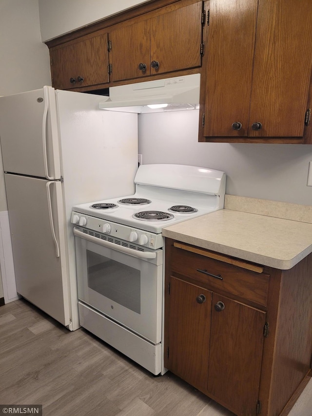 kitchen featuring white range oven and light hardwood / wood-style floors