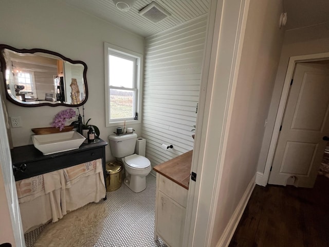 bathroom featuring wood-type flooring, vanity, and toilet