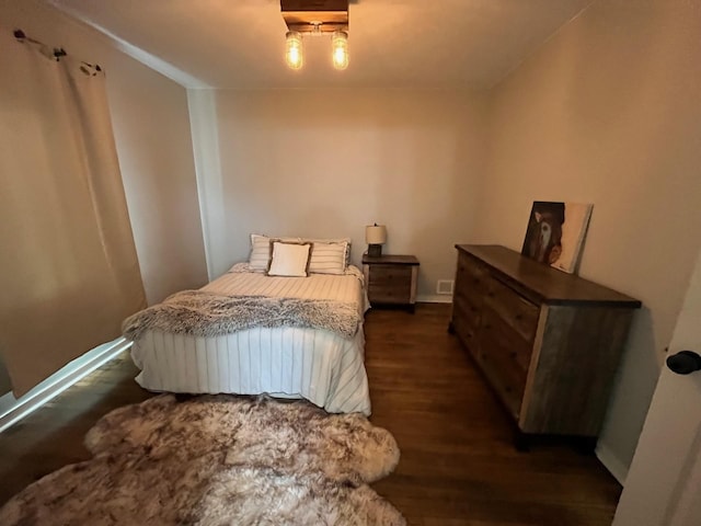 bedroom with dark hardwood / wood-style flooring