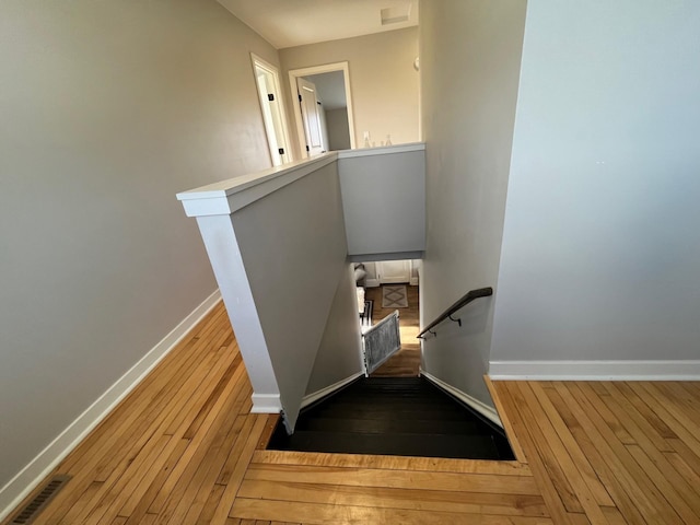 stairway with hardwood / wood-style floors