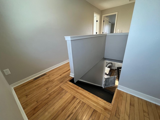 stairs with hardwood / wood-style floors