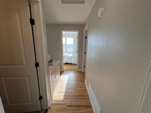 corridor with light hardwood / wood-style floors