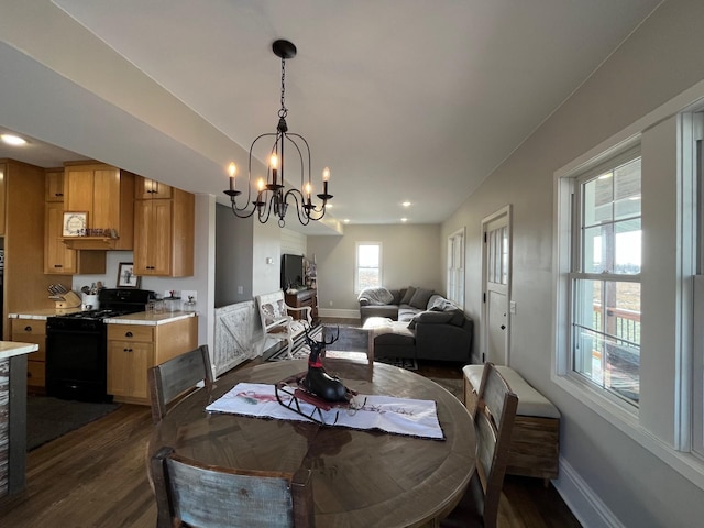 dining area featuring dark hardwood / wood-style flooring and a notable chandelier