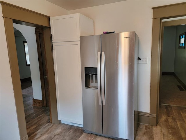 kitchen with white cabinetry, stainless steel fridge with ice dispenser, and dark hardwood / wood-style flooring