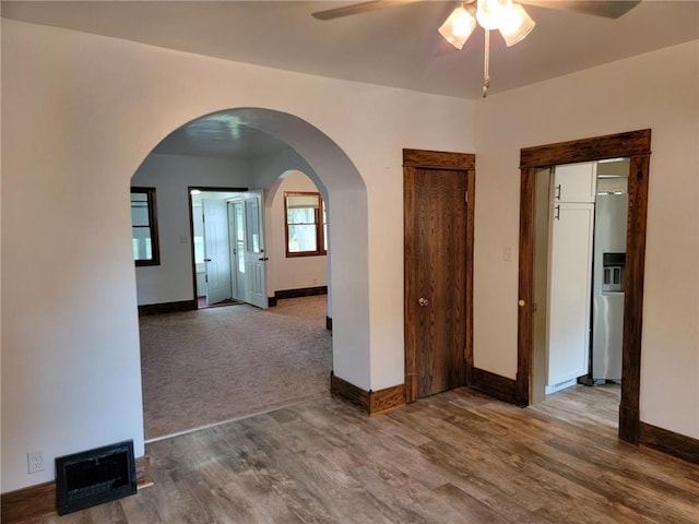 unfurnished room with hardwood / wood-style flooring and ceiling fan