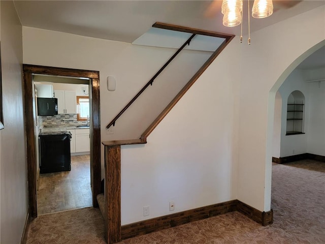 staircase with hardwood / wood-style flooring