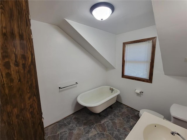 bathroom with a bathing tub, sink, and toilet