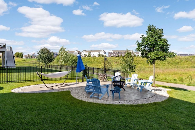 view of play area featuring a fire pit, a patio area, and a lawn