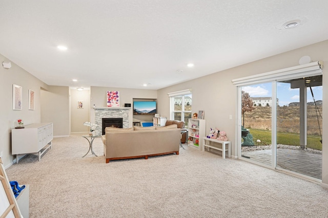 carpeted living room featuring a fireplace