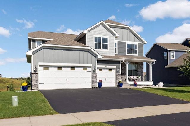 craftsman-style house with a garage, a porch, and a front yard