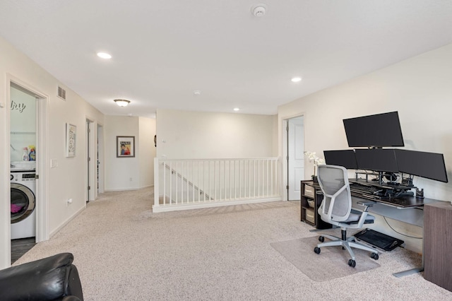 office featuring light colored carpet and washer / dryer