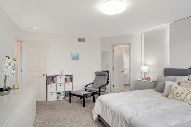 carpeted bedroom with ensuite bath