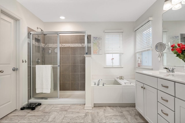 bathroom featuring shower with separate bathtub and vanity