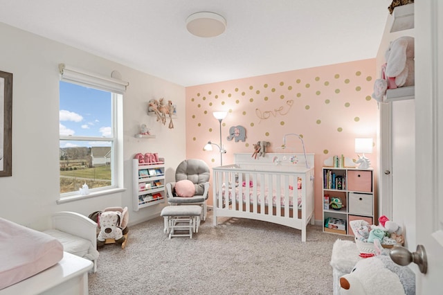 carpeted bedroom featuring a crib