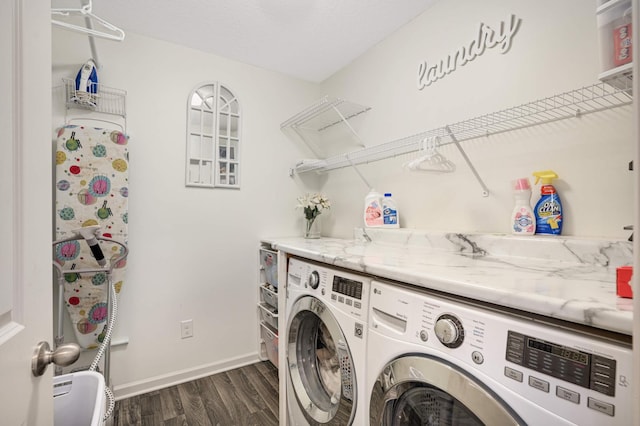 laundry area featuring washing machine and dryer and dark hardwood / wood-style floors