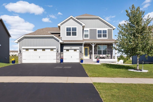 craftsman inspired home with covered porch and a front lawn