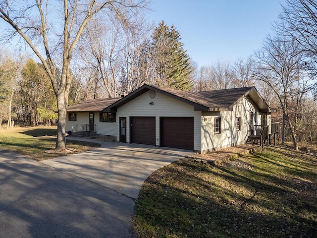 ranch-style house with a garage and a front lawn