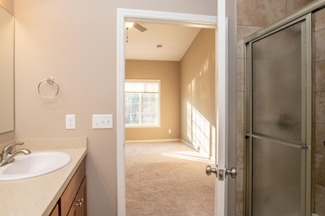 bathroom featuring vanity, ceiling fan, and a shower with door